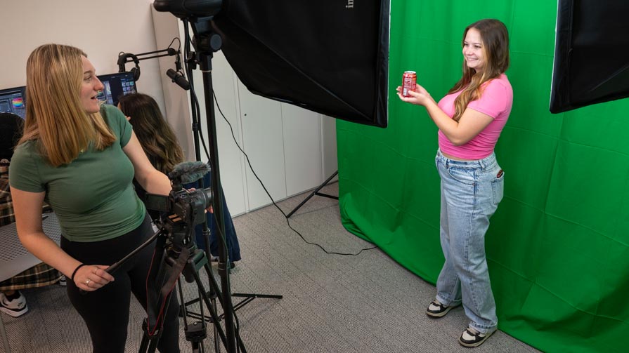 Students practice filming an advertising spot in Bryant's new Digital Marketing Lab